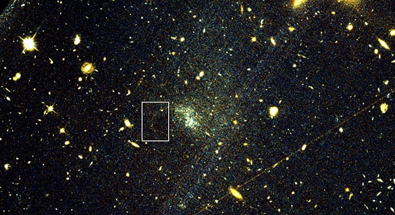 Illustration of a faint stellar stream arcing through a dim, diffuse galaxy.